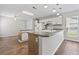 Bright kitchen featuring white cabinetry, center island, and a window offering natural light at 1406 Snowy Egret Dr., Murrells Inlet, SC 29576