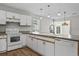 Functional kitchen with white cabinetry, wood-look flooring, and ample counter space at 1406 Snowy Egret Dr., Murrells Inlet, SC 29576