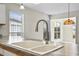 Close-up of the kitchen sink and countertops with views to adjacent living area at 1406 Snowy Egret Dr., Murrells Inlet, SC 29576