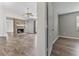 Open living room featuring hardwood floors and a traditional brick fireplace at 1406 Snowy Egret Dr., Murrells Inlet, SC 29576