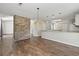 Spacious living room featuring an exposed brick wall and hardwood flooring at 1406 Snowy Egret Dr., Murrells Inlet, SC 29576