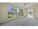Bright living room featuring large windows and sliding glass doors leading to the outdoor area at 1406 Snowy Egret Dr., Murrells Inlet, SC 29576