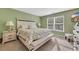 Charming bedroom features a floral comforter and a sunlit window at 146 Brittmore Park Pl., Myrtle Beach, SC 29588