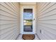 Close-up of front door with a glass panel, a decorative wreath, and an elegant door mat at 146 Brittmore Park Pl., Myrtle Beach, SC 29588