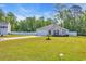 Charming single-story home featuring a green lawn, concrete driveway, and an attached garage at 146 Brittmore Park Pl., Myrtle Beach, SC 29588