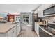 Bright kitchen featuring white cabinets, stainless steel appliances, and an eat-in counter facing the backyard at 146 Brittmore Park Pl., Myrtle Beach, SC 29588