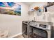 Well-equipped laundry room with modern Samsung washer and dryer and a shelf for storage at 146 Brittmore Park Pl., Myrtle Beach, SC 29588