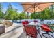 Inviting backyard pool with an outdoor dining area, grill, and lush green trees at 146 Brittmore Park Pl., Myrtle Beach, SC 29588