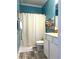 Well-lit bathroom showcasing a tub with a shower curtain and a single sink vanity at 1516 Edge Dr. # 101, North Myrtle Beach, SC 29582