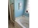 Bathroom with a glass-enclosed shower and a soaking tub under a window with decorative glass blocks at 1516 Edge Dr. # 101, North Myrtle Beach, SC 29582