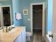 Bright bathroom with a vanity, toilet, and a storage closet at 1516 Edge Dr. # 101, North Myrtle Beach, SC 29582