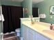Bathroom featuring double sink vanity, toilet, and shower with curtain at 1516 Edge Dr. # 101, North Myrtle Beach, SC 29582