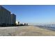 View of the beach featuring tall buildings, light sand, and the ocean at 1516 Edge Dr. # 101, North Myrtle Beach, SC 29582