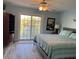 Bedroom featuring a queen-sized bed, wood-look floors, and access to outdoor balcony at 1516 Edge Dr. # 101, North Myrtle Beach, SC 29582