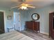 Cozy bedroom with soft blue walls, hardwood floors, a dresser, and an open doorway to the en-suite bath at 1516 Edge Dr. # 101, North Myrtle Beach, SC 29582