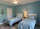 Charming bedroom featuring two twin beds with matching decor and coastal-themed accents at 1516 Edge Dr. # 101, North Myrtle Beach, SC 29582