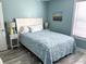 Inviting bedroom with a queen bed, ceiling fan, and a large window for natural light at 1516 Edge Dr. # 101, North Myrtle Beach, SC 29582