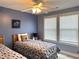 Bedroom featuring two beds, ceiling fan, and stylish decor at 1516 Edge Dr. # 101, North Myrtle Beach, SC 29582