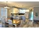 Open dining and kitchen area featuring a wood table, white chairs, and modern appliances at 1516 Edge Dr. # 101, North Myrtle Beach, SC 29582