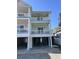 Three story condo featuring a pale green exterior, white railings, and outdoor balconies at 1516 Edge Dr. # 101, North Myrtle Beach, SC 29582