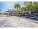 Golf carts parked near a blue beach access building surrounded by palm trees offer a fun mode of transportation at 1516 Edge Dr. # 101, North Myrtle Beach, SC 29582