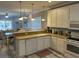 Open kitchen featuring white cabinets, a view to the dining room, and modern appliances at 1516 Edge Dr. # 101, North Myrtle Beach, SC 29582