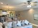Open-concept living area featuring a comfortable couch, dining space, and a breakfast bar with modern pendant lighting at 1516 Edge Dr. # 101, North Myrtle Beach, SC 29582