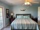 Serene bedroom with blue walls, a comfortable bed, and natural light streaming in from the sliding glass door at 1516 Edge Dr. # 101, North Myrtle Beach, SC 29582