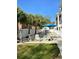 Community pool with lounge chairs and blue umbrella, surrounded by palm trees at 1516 Edge Dr. # 101, North Myrtle Beach, SC 29582