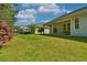 Expansive backyard with lush green grass and a covered patio area for outdoor living at 1581 Culbertson Ave., Myrtle Beach, SC 29577