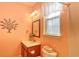 Bathroom features a sink, toilet, a mirror, and soft lighting at 1581 Culbertson Ave., Myrtle Beach, SC 29577