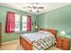 Cozy bedroom with green walls, a wood bed, red curtains and natural light from the windows at 1581 Culbertson Ave., Myrtle Beach, SC 29577