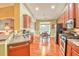 Well-lit kitchen featuring stainless steel appliances, cherry cabinets, and hardwood floors at 1581 Culbertson Ave., Myrtle Beach, SC 29577