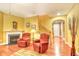 Cozy living room area with red armchairs, fireplace, staircase, and stylish decor at 1581 Culbertson Ave., Myrtle Beach, SC 29577