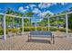 Bench in the community seating area with a pergola, lush greenery, and access to the pool at 1581 Culbertson Ave., Myrtle Beach, SC 29577