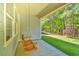 Covered porch with a wooden swing, offering a relaxing outdoor space overlooking the yard at 1581 Culbertson Ave., Myrtle Beach, SC 29577