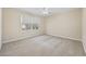 This carpeted bedroom features a ceiling fan and a window with natural light at 1623 27Th Ave. N, North Myrtle Beach, SC 29582