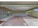 A spacious carport made from concrete, enclosed by screen and lattice, providing protection from the elements at 1623 27Th Ave. N, North Myrtle Beach, SC 29582
