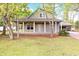 Charming home featuring a covered front porch and mature trees at 1623 27Th Ave. N, North Myrtle Beach, SC 29582