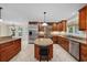 This is a spacious kitchen with a center island, stainless steel appliances, and warm wood cabinetry at 1623 27Th Ave. N, North Myrtle Beach, SC 29582
