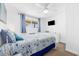 Bright bedroom featuring a full bed, ceiling fan, and dresser with TV at 1919 Spring St. # 36A, North Myrtle Beach, SC 29582