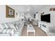 Comfortable living room with striped sofa, ceiling fan, and adjacent dining and kitchen area at 1919 Spring St. # 36A, North Myrtle Beach, SC 29582