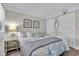 Serene bedroom with wood floor, nautical decor, and a comfortable bed setting at 2001 S Ocean Blvd. # 406, Myrtle Beach, SC 29577