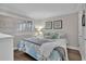 Bright bedroom with wood floor, coastal decor, plantation shutters, and a cozy bed arrangement at 2001 S Ocean Blvd. # 406, Myrtle Beach, SC 29577