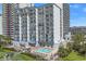Resort-style building with multiple balconies and a sparkling outdoor pool area, perfect for relaxation and recreation at 2001 S Ocean Blvd. # 406, Myrtle Beach, SC 29577
