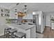 Modern kitchen with stainless steel appliances, white cabinets, and a breakfast bar for casual dining at 2001 S Ocean Blvd. # 406, Myrtle Beach, SC 29577
