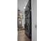 Laundry area features gray stacked washer/dryer, water heater and storage for efficient space use at 2001 S Ocean Blvd. # 406, Myrtle Beach, SC 29577