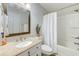 Bathroom featuring granite counters, bronze hardware, framed mirror and shower with white curtain at 202 Landing Rd. # B, North Myrtle Beach, SC 29582