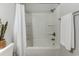 Bathroom featuring a white shower and bathtub with a white shower curtain and chrome fixtures at 202 Landing Rd. # B, North Myrtle Beach, SC 29582