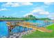 Scenic view of a wooden dock extending into the waterway with lush landscaping at 202 Landing Rd. # B, North Myrtle Beach, SC 29582